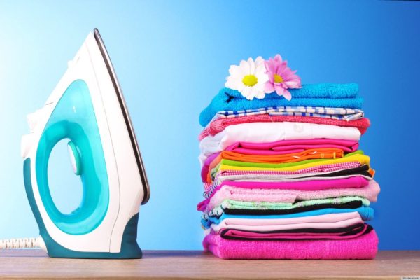 Pile of colorful clothes and electric iron  on blue background; Shutterstock ID 74612842; PO: The Huffington Post; Job: The Huffington Post; Client: The Huffington Post; Other: The Huffington Post